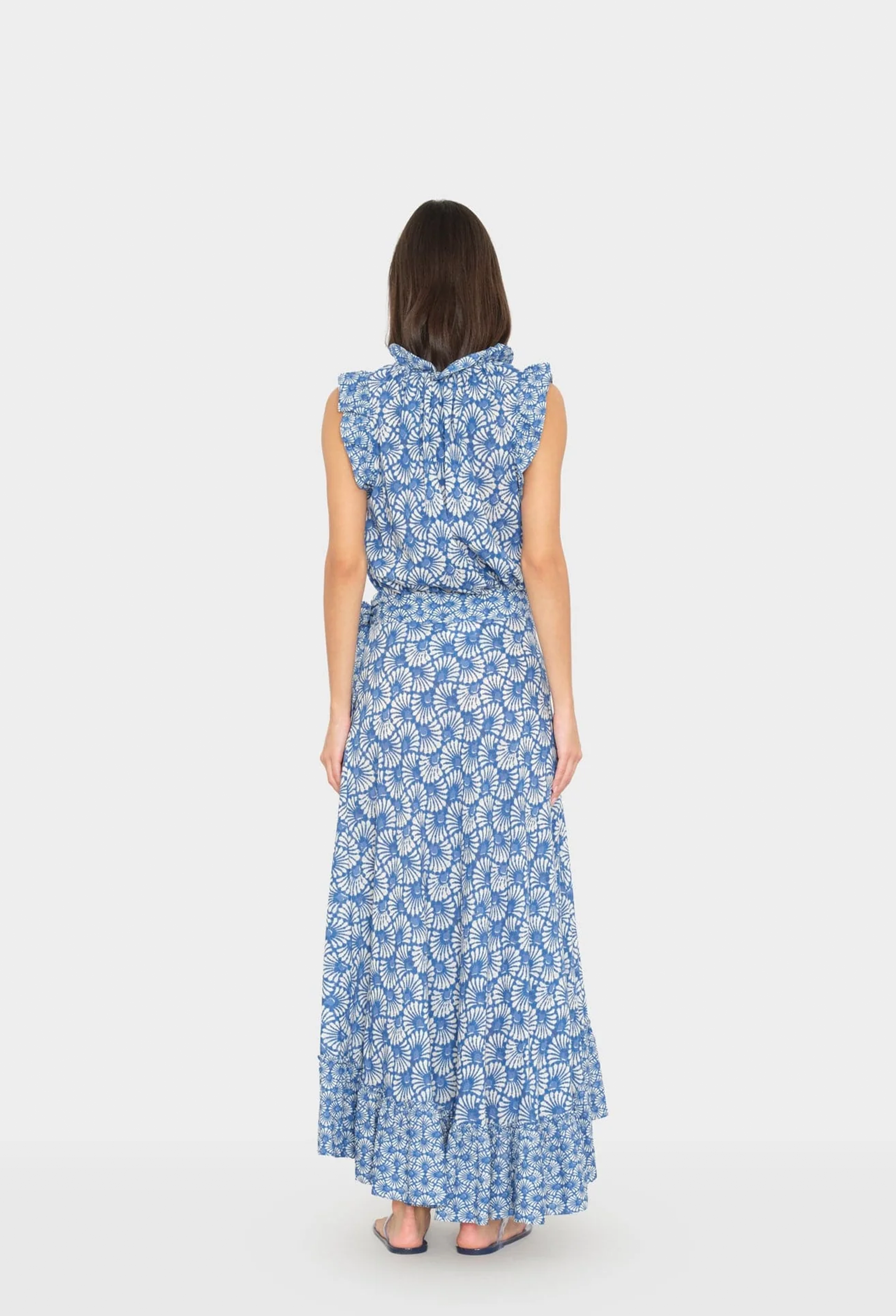 Woman wearing a blue floral dress on a white background
