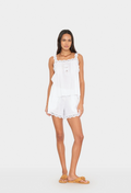 Woman wearing a white lace top and shorts on a white background