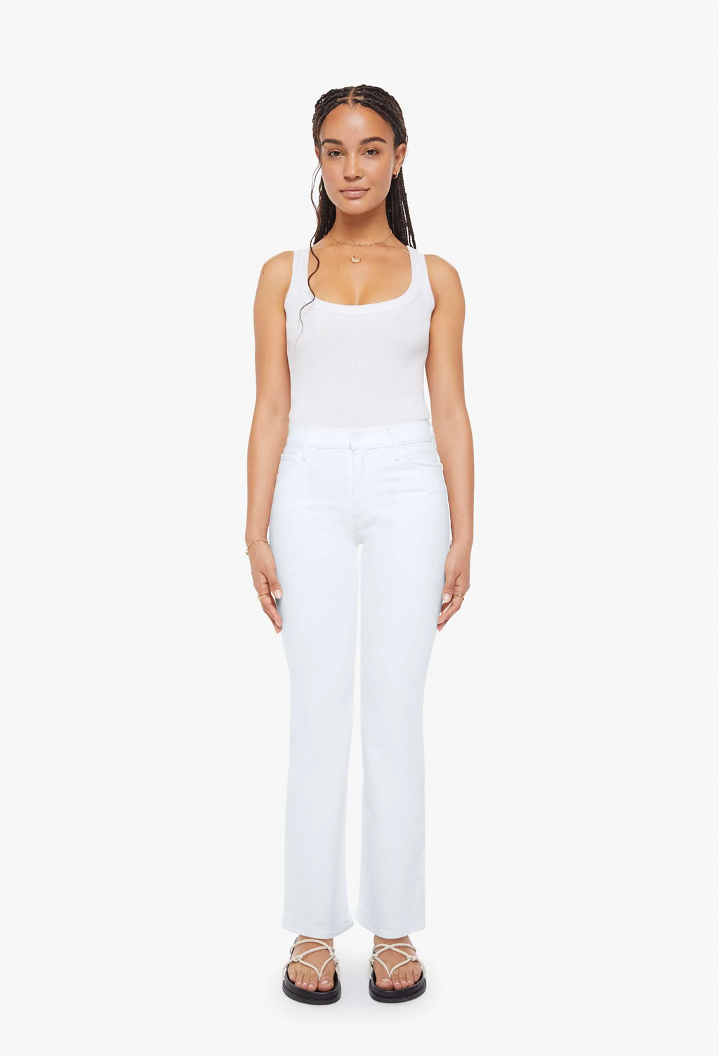 Woman wearing a white sleeveless top and pants on a white background
