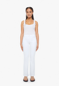 Woman wearing a white sleeveless top and pants on a white background