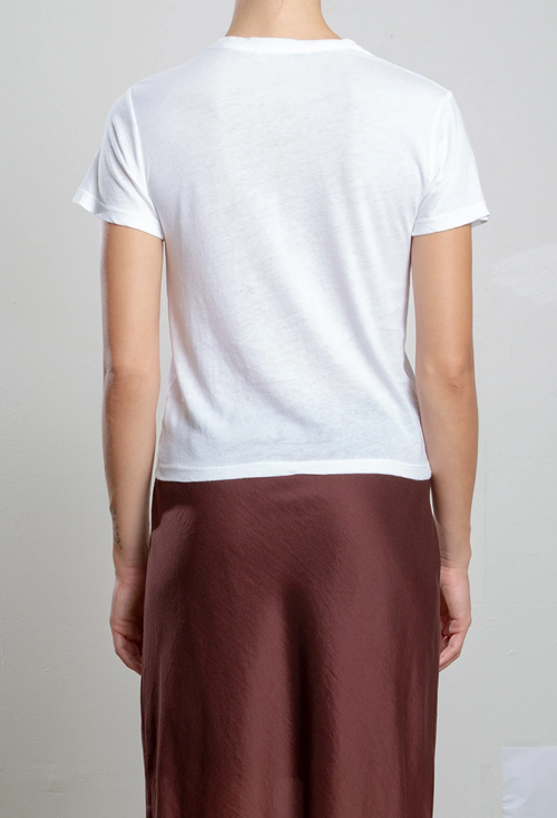 Person wearing a white t-shirt and brown pants on a plain background