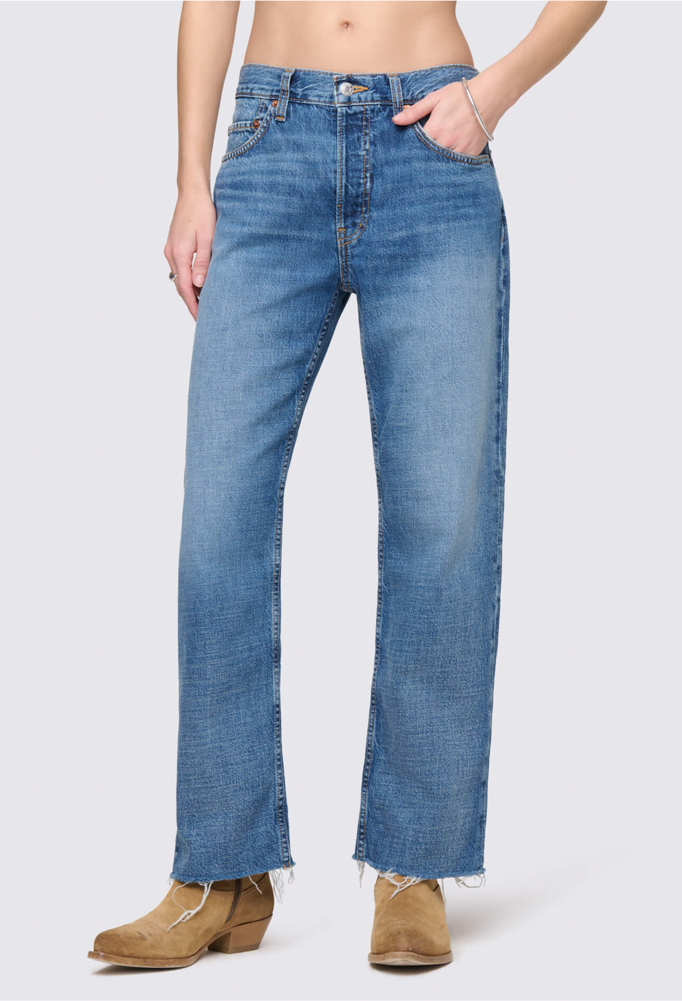 Person wearing blue jeans on a white background