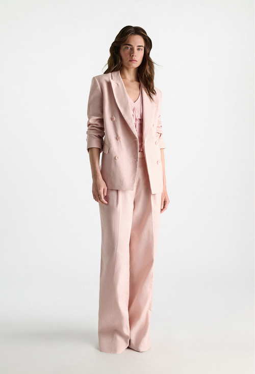 Woman wearing a pink suit on a white background
