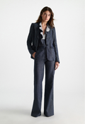 Woman wearing a blue suit with a white shirt on a white background