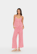 Woman wearing a pink checkered top and pants on a white background