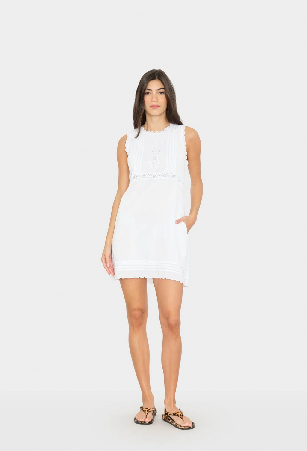 Woman wearing a white sleeveless dress on a white background