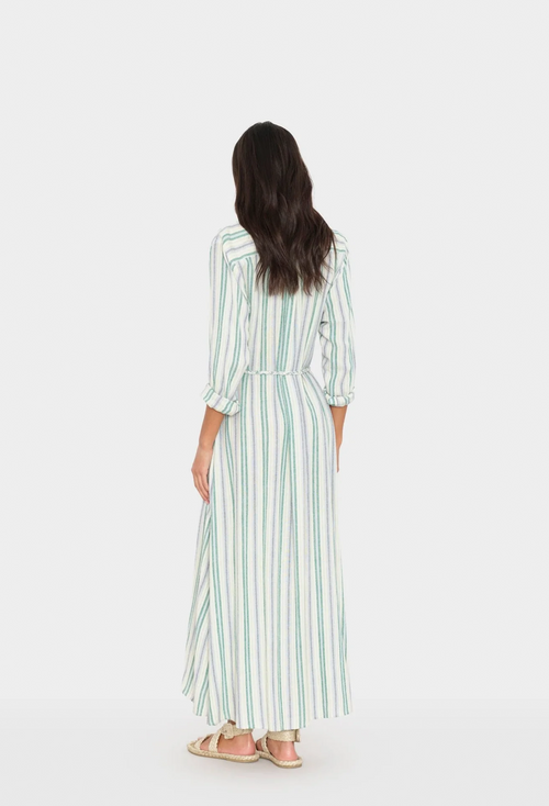 Woman wearing a long striped dress on a white background