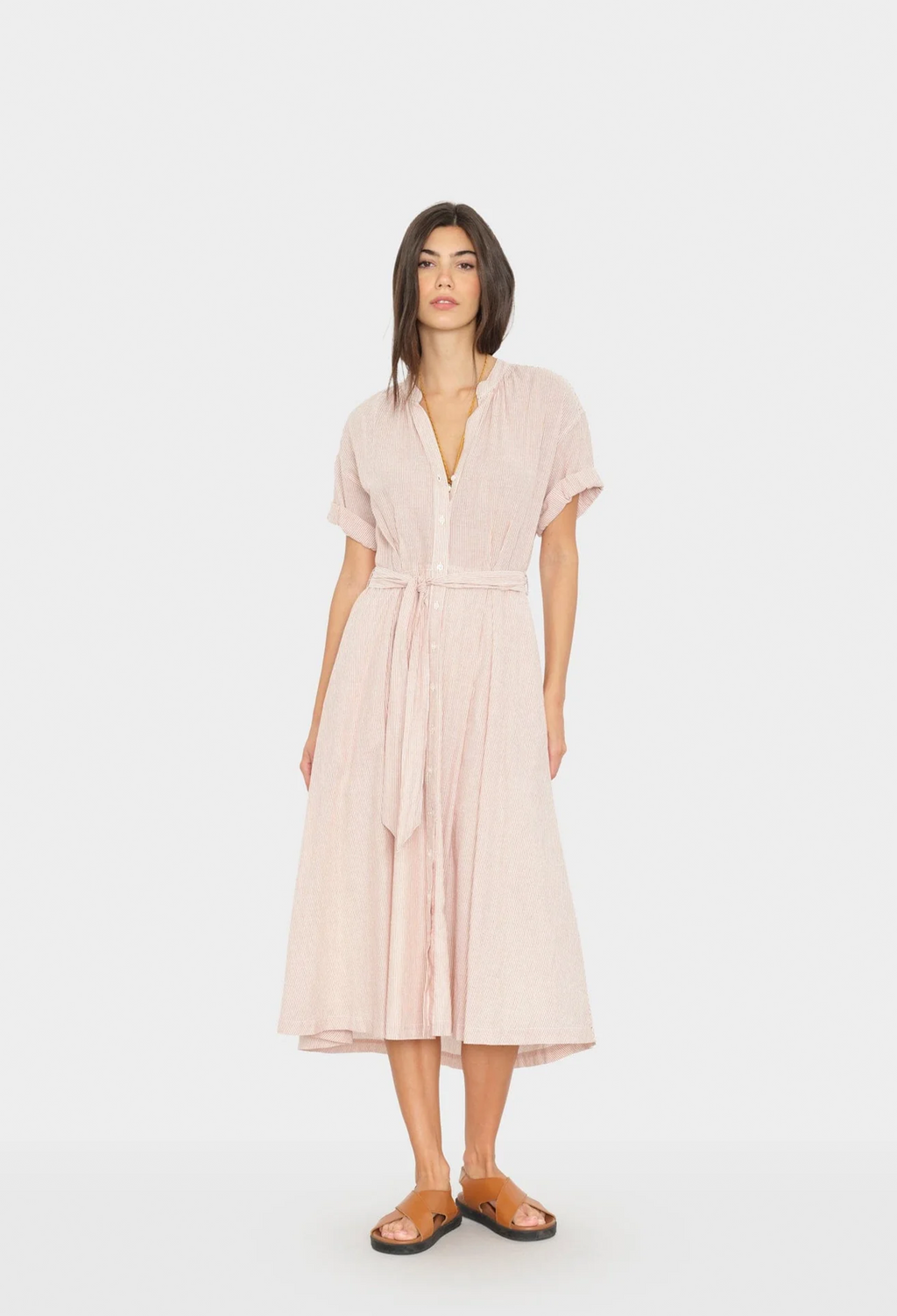 Woman wearing a light pink dress on a white background