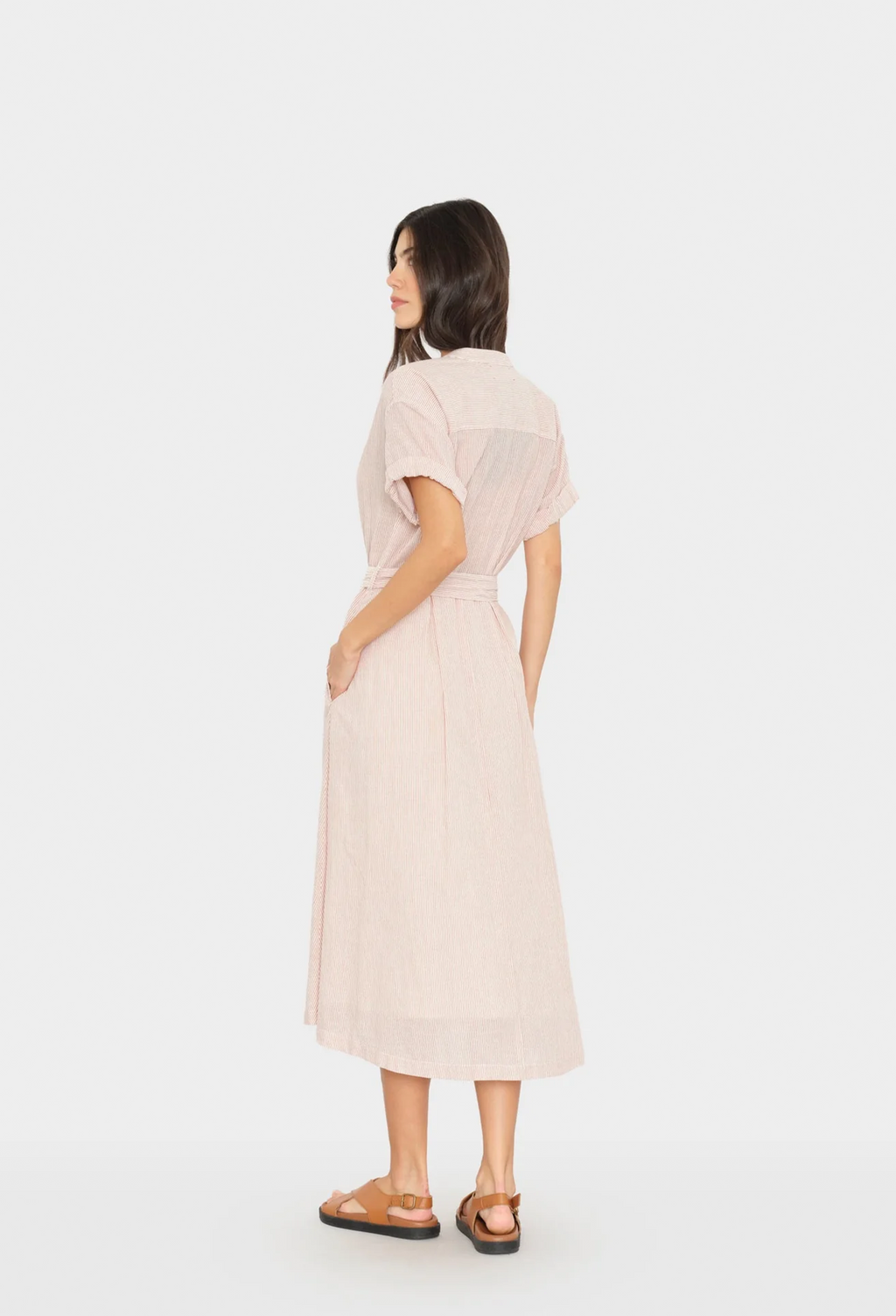 Woman wearing a light pink dress on a white background