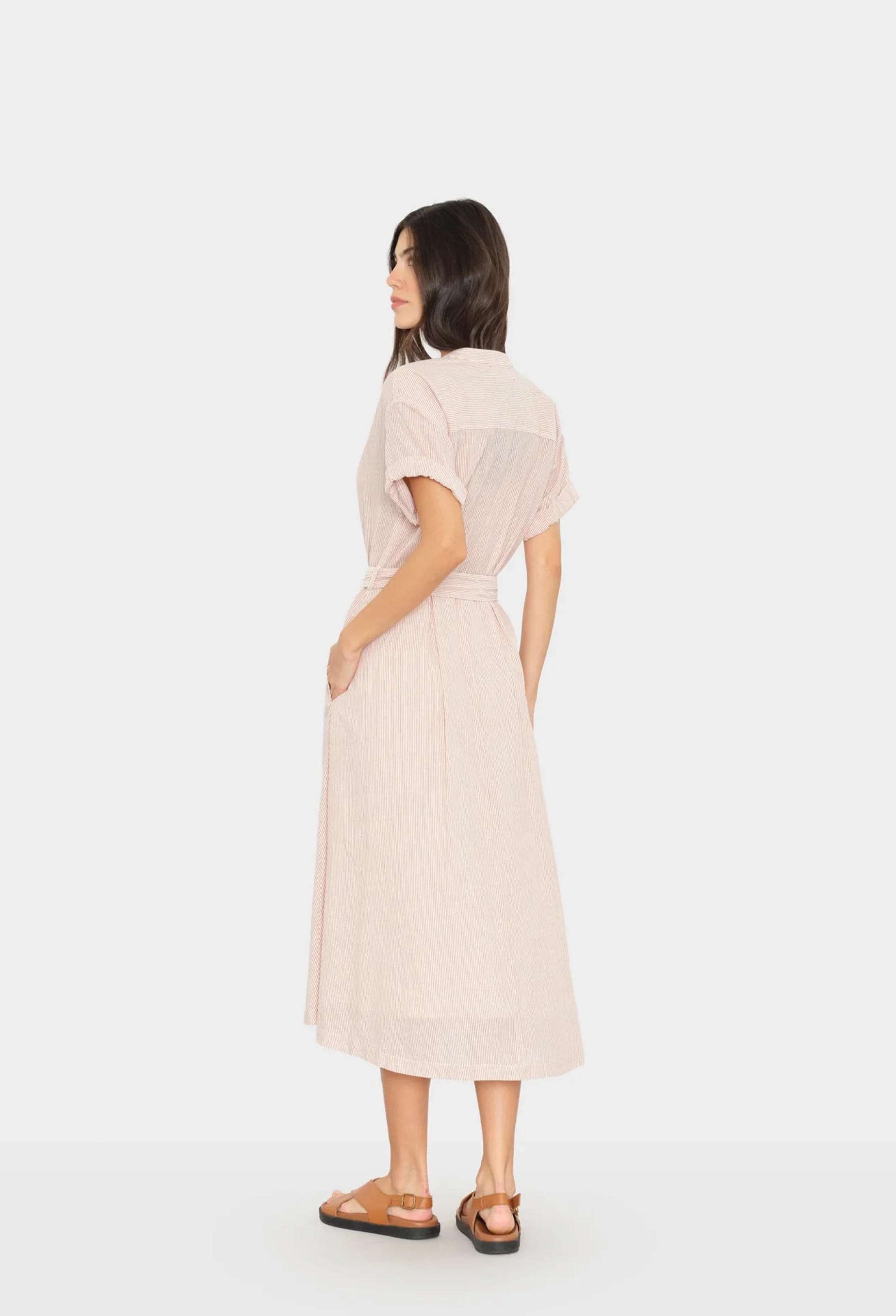 Woman wearing a light pink dress on a white background