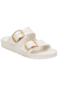 White sandal with gold buckles on a white background