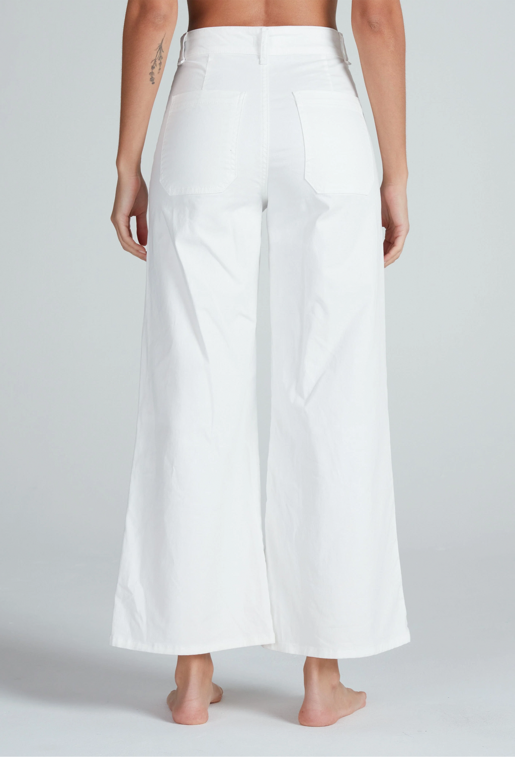 White wide-leg pants worn by a person on a plain background