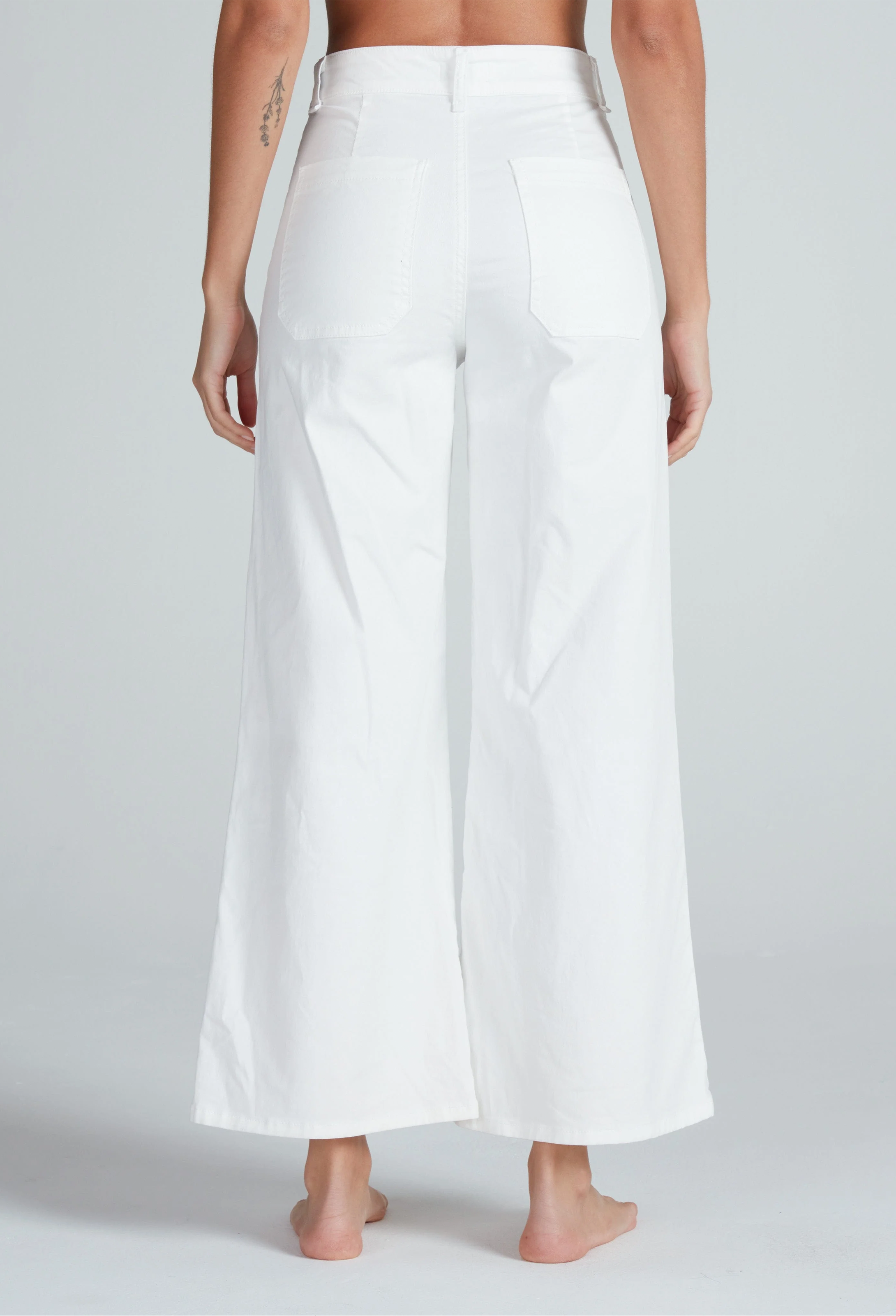 White wide-leg pants worn by a person on a plain background