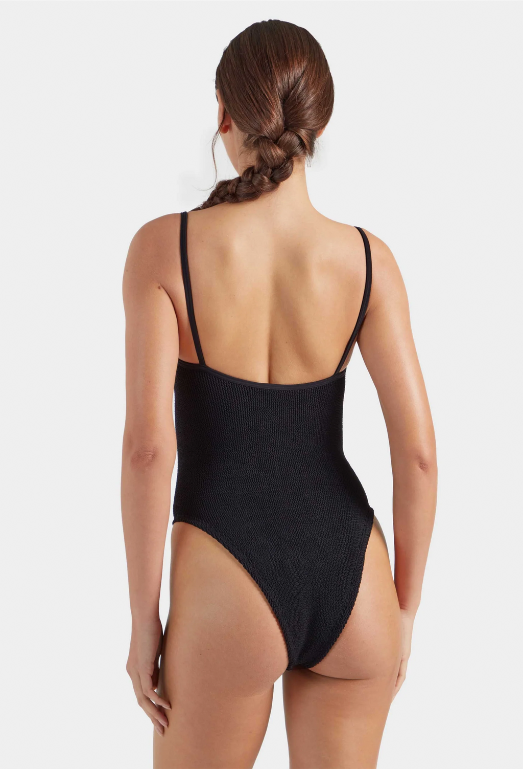 Person wearing a black swimsuit on a white background