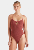 Woman wearing a red swimsuit against a white background