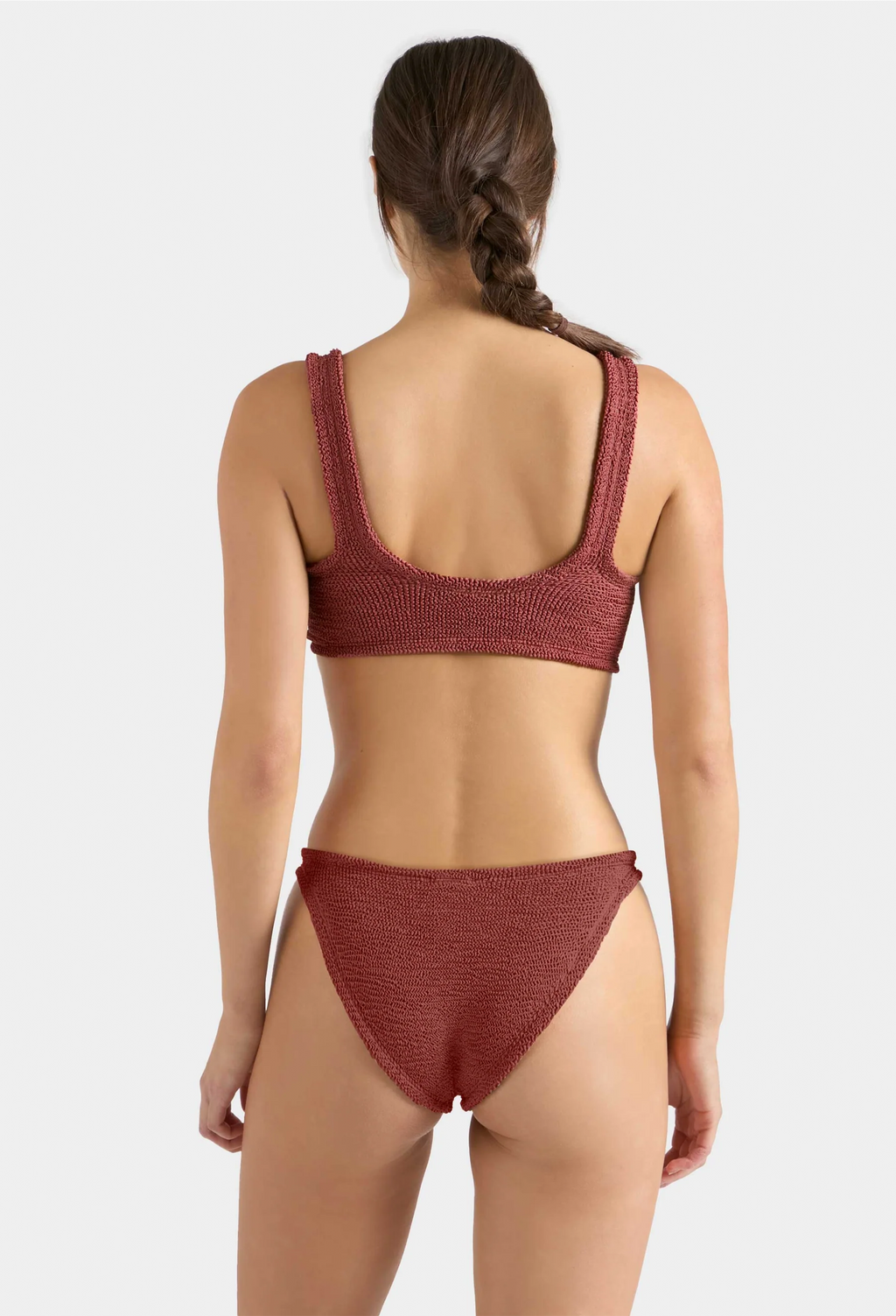 Woman wearing a red bikini set on a white background
