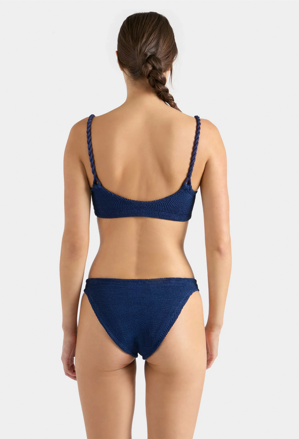 Woman wearing a blue bikini set on a white background
