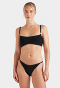 Woman wearing a black bikini on a white background