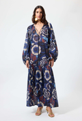 Woman wearing a blue floral patterned dress on a white background
