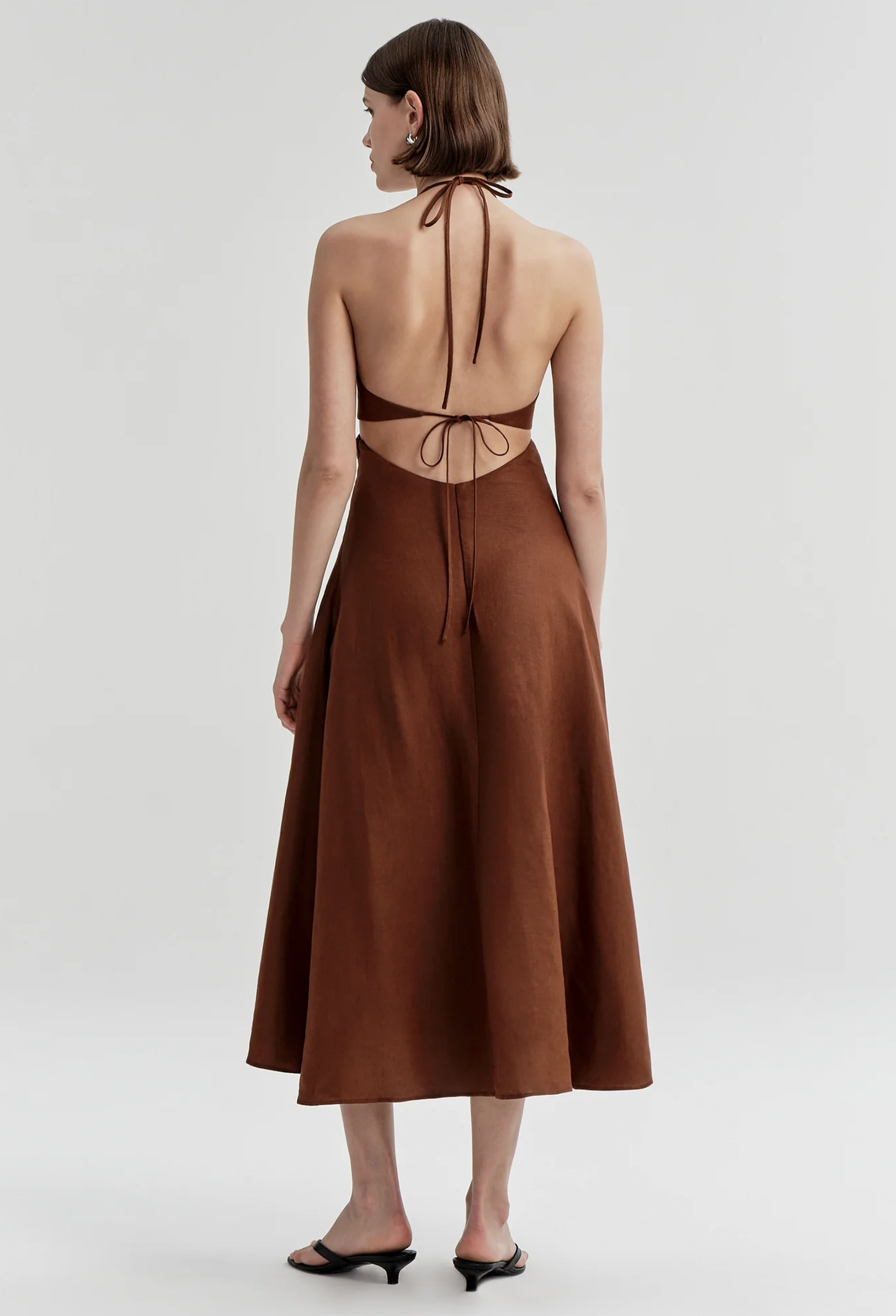 Brown halter neck dress on a white background