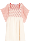 Pink dress with red lattice pattern and cream skirt on a white background