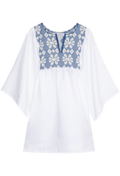 White blouse with blue floral embroidery on a white background