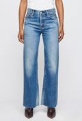 Person wearing blue jeans on a white background
