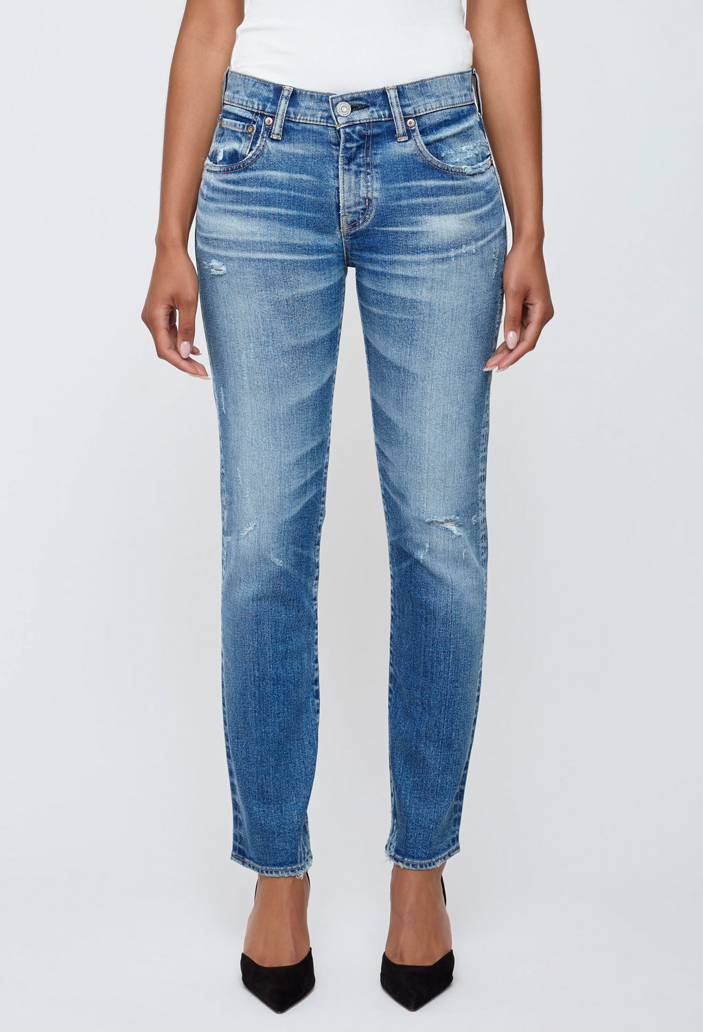 Blue jeans worn by a person on a white background