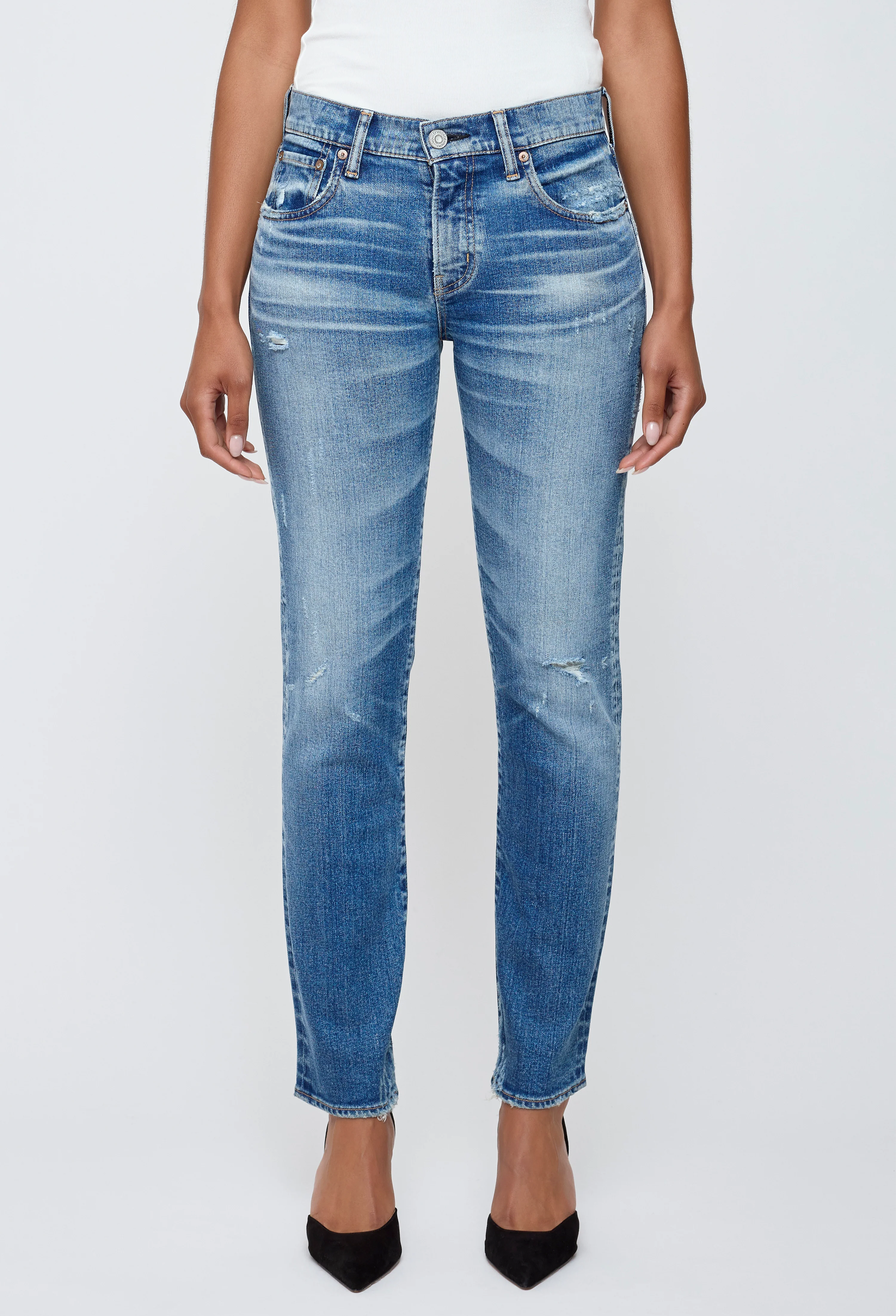 Blue jeans worn by a person on a white background
