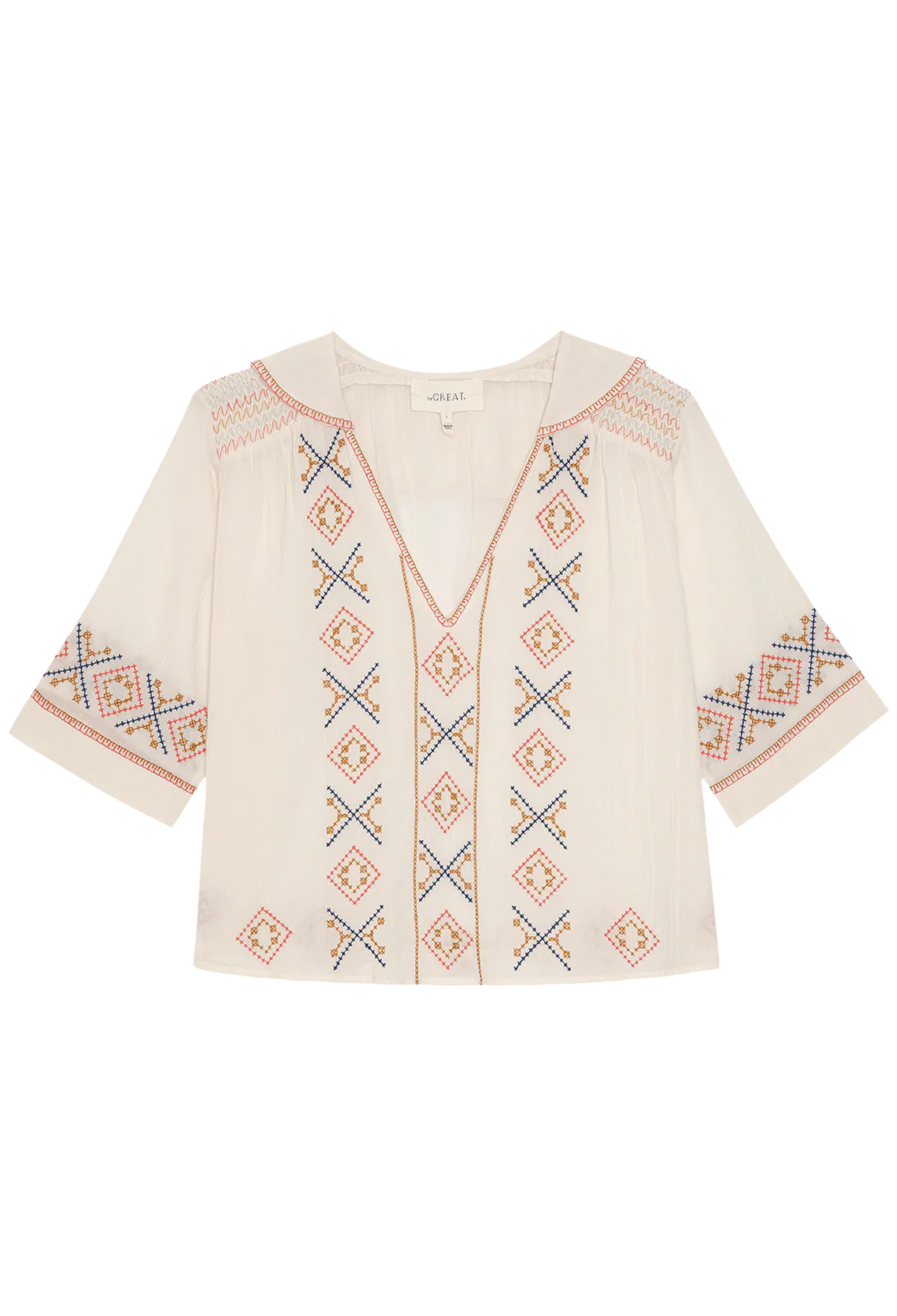 Beige blouse with colorful geometric patterns on a white background