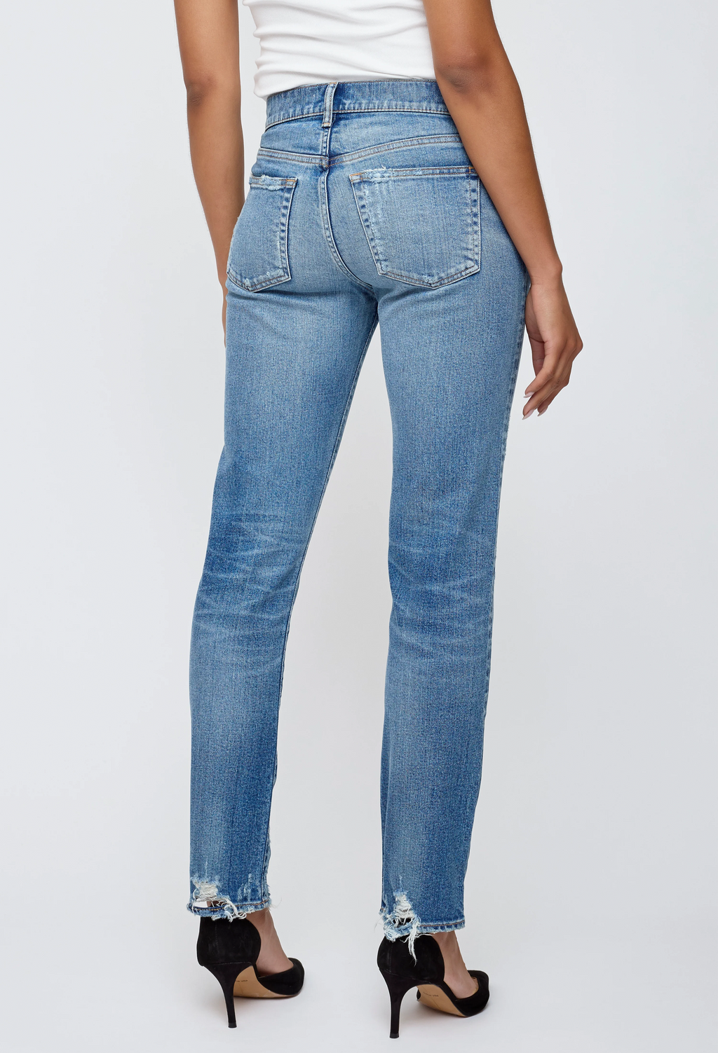 Light blue jeans worn by a person on a white background