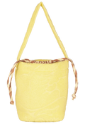 A light yellow woven bucket bag with a single shoulder strap and a brown and beige patterned drawstring closure at the top, shown against a plain white background.