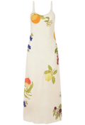 An off-white sleeveless maxi dress with a colorful fruit and floral print, featuring thin shoulder straps, shown against a plain white background.