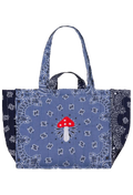 A quilted tote bag featuring a blue bandana print with a central red and white mushroom design, set against a plain white background.