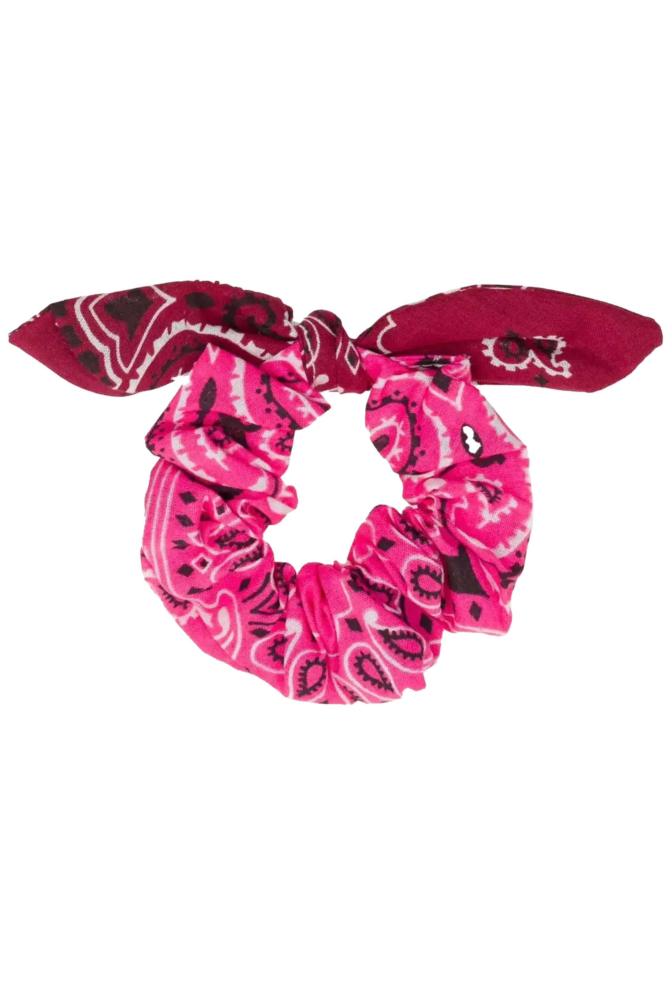A fabric scrunchie with a bow detail, featuring a vibrant pink and magenta paisley bandana pattern with black accents, isolated on a white background.