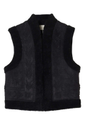 A black sleeveless vest featuring a plush fur collar, hem, and lining, with matching black textured panels and starburst embroidery on the front.