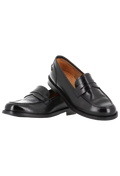 Pair of black calf leather loafers. Set against a checkered background. 