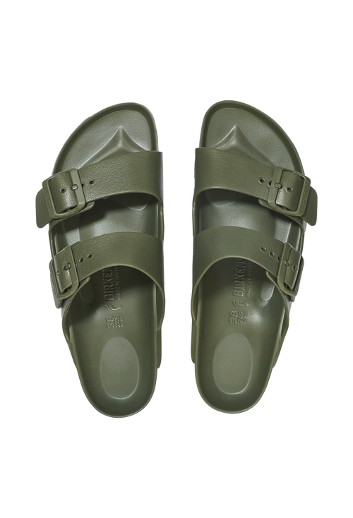A pair of all-green two strap buckle sandals. Transparent background