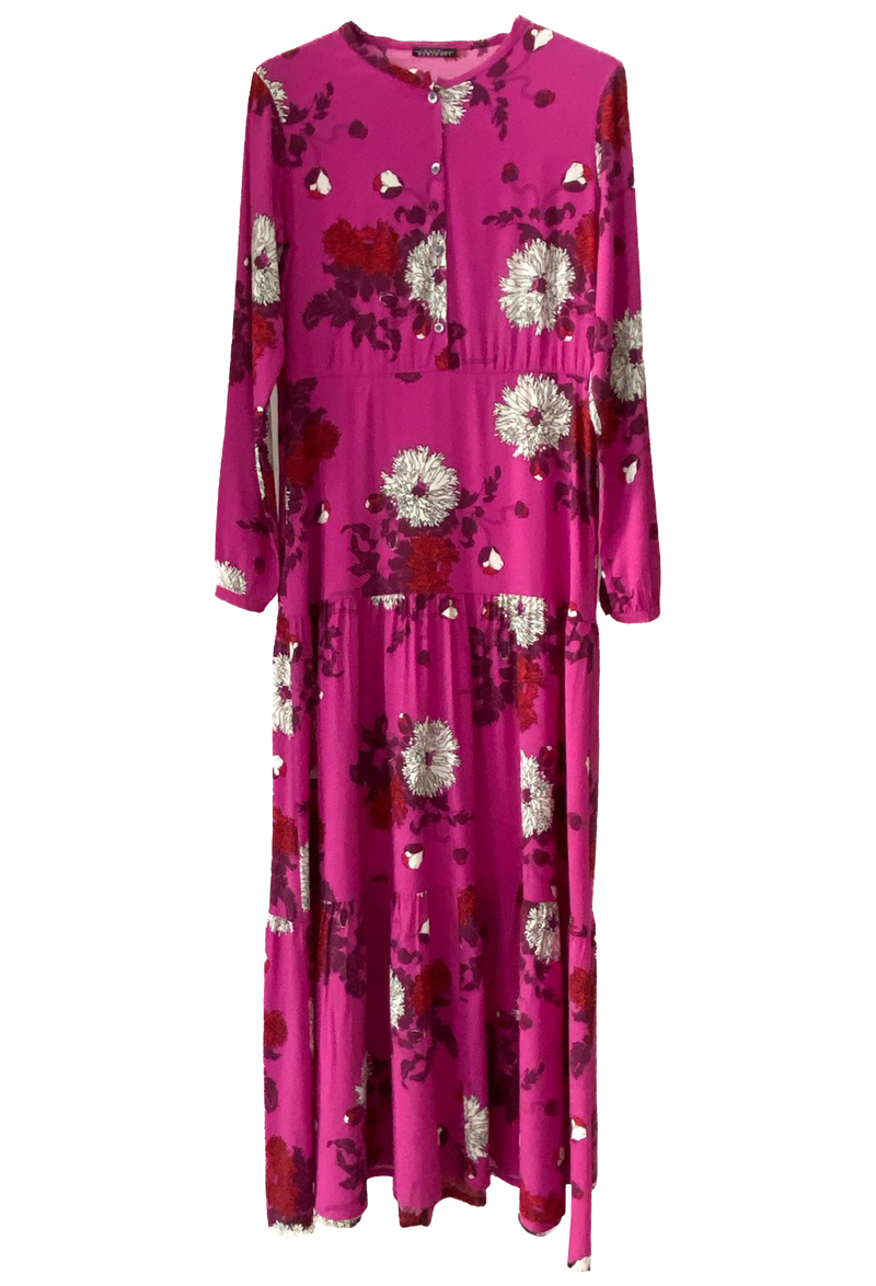 A long floral hot pink dress with a tiered skirt and long sleeves.