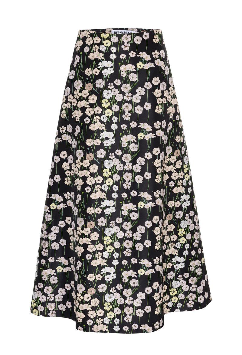 A long black skirt with a pastel colored flowers print. White background.
