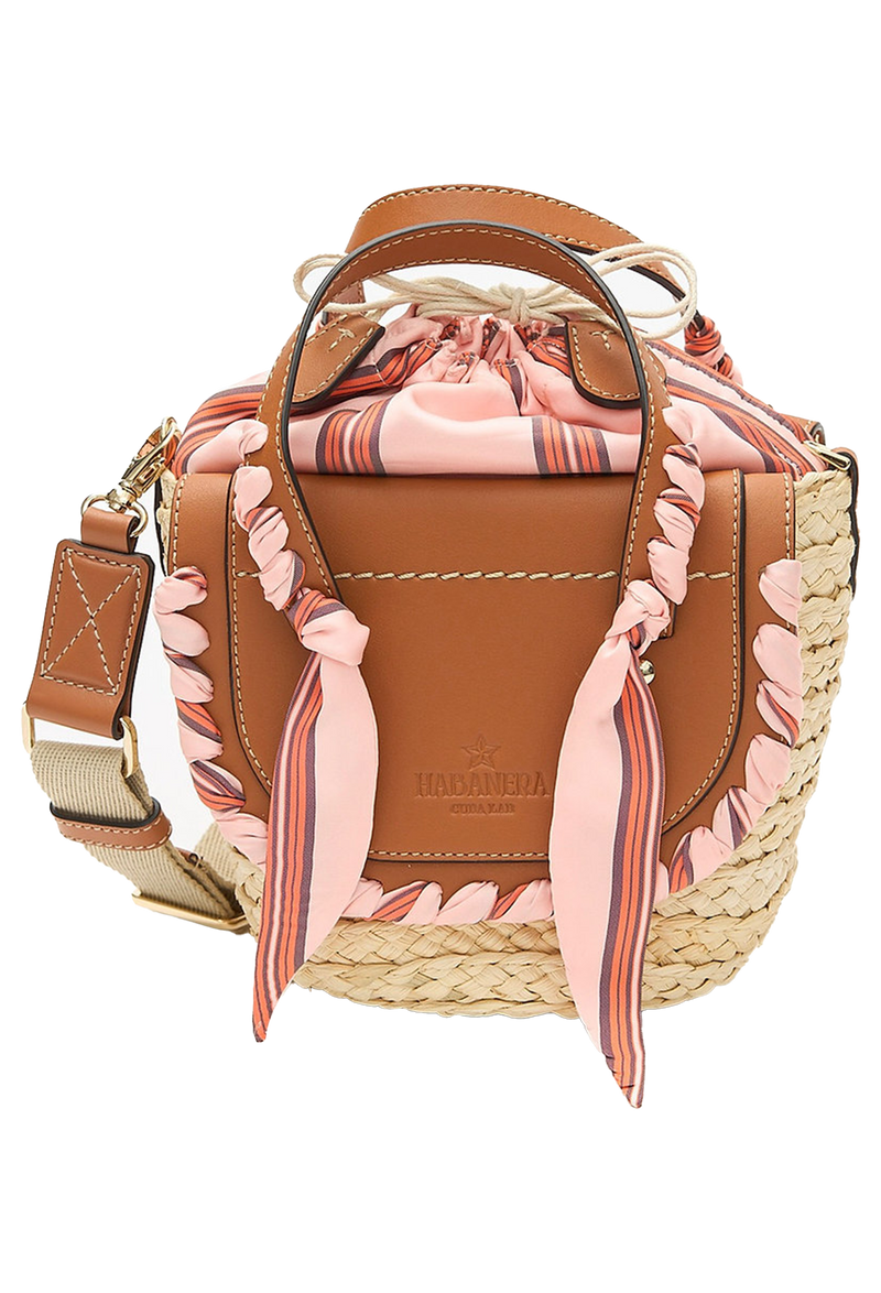 A mini basket bag with beige leather flaps, pink ribbon detailing, and two small leather handles and a crossbody strap. Transparent background.