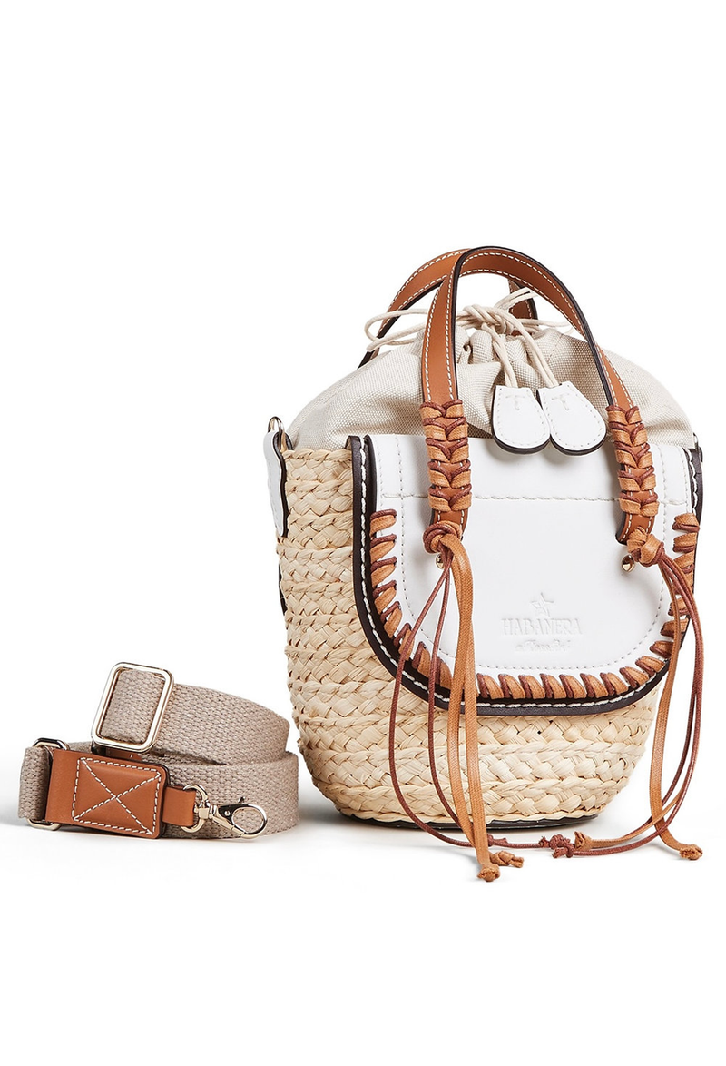 A mini basket bag with white leather flaps, brown cord detailing, and two small leather handles and a crossbody strap. White background.