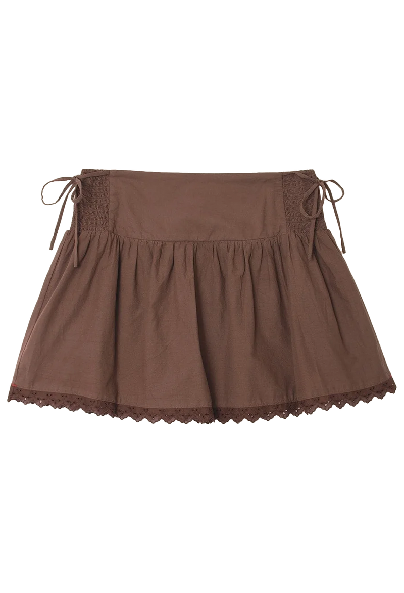 A brown skirt with ties at each side and a scalloped lace trim. Transparent background.