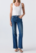 Close up of a woman wearing a white tank top and blue jeans. Taken on a white background.
