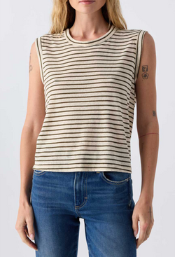 Close up of a woman wearing jeans and an off white sleeveless tee with brown stripes. Taken on a white background.