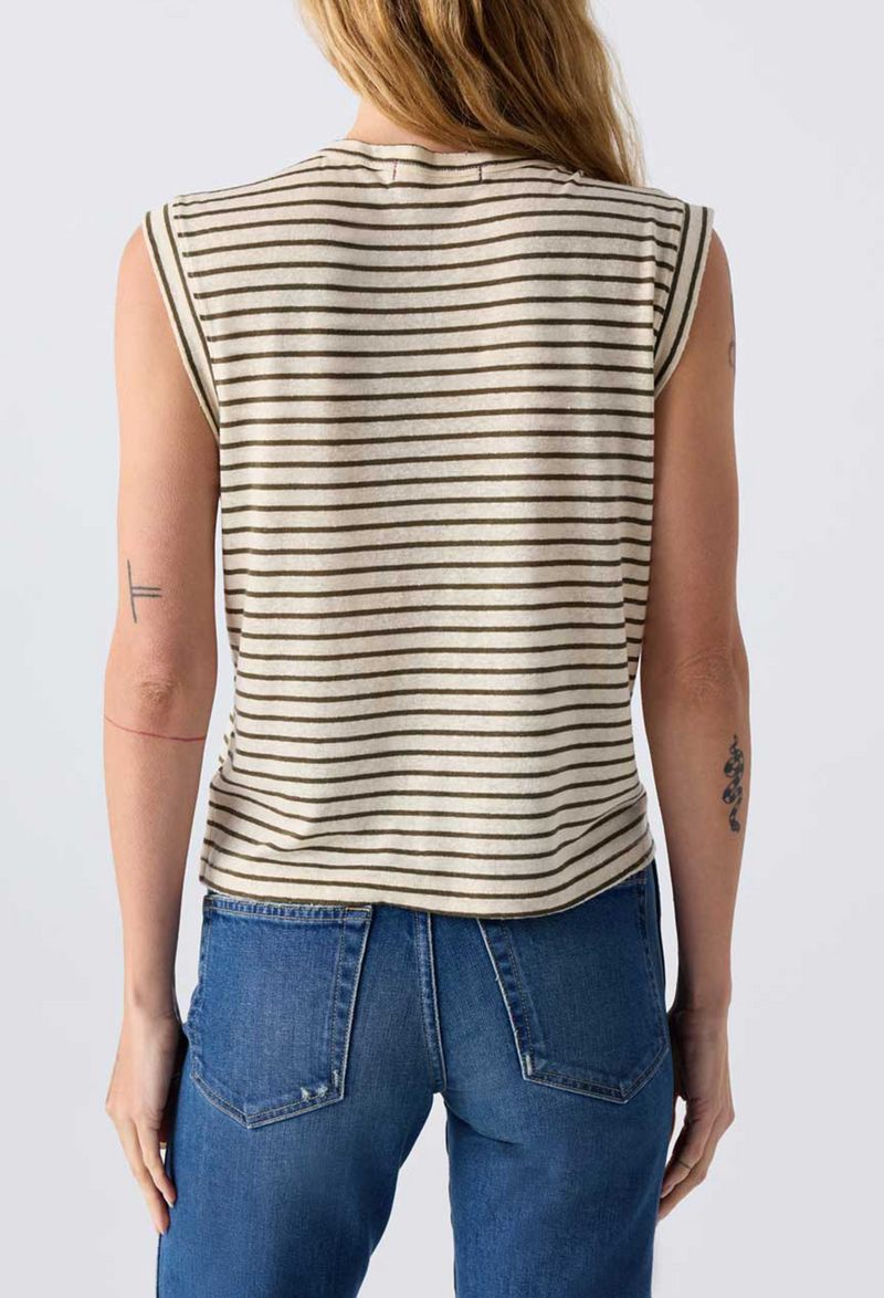 Close up of the back of a woman wearing jeans and an off white sleeveless tee with brown stripes. Taken on a white background.