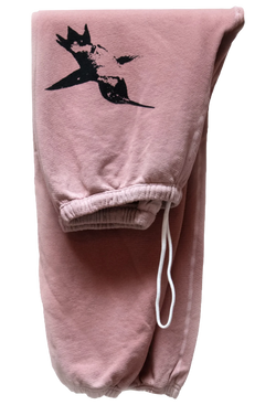 A pair of folded pink sweatpants with a black screen printed bird on the thigh and a drawstring. Transparent background.