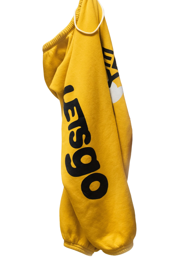 A pair of folded yellow sweatpants with letsgo printed in black lettering. Transparent background.