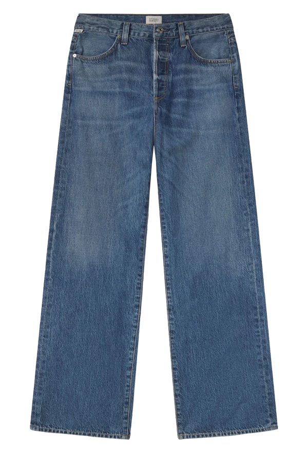 Wide leg dark wash blue jeans set against a checkered background. 