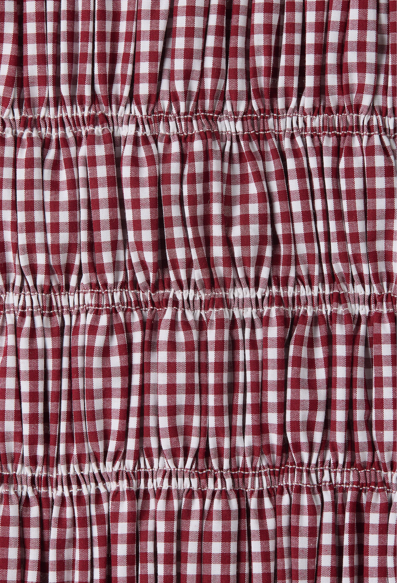 Detail shot of shirred red and white gingham print fabric.